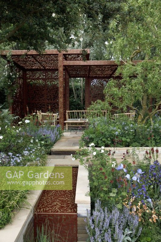 In the Morris  and  Co. Garden, a water channel built with Yorkshire stone is inlaid with a metal screen,  laser-cut with Morris's 'Willow Boughs 'pattern, which is also reproduced on the handcrafted metal pavilion - Designer: Ruth Willmott - Sponsor: Morris  and  Co.