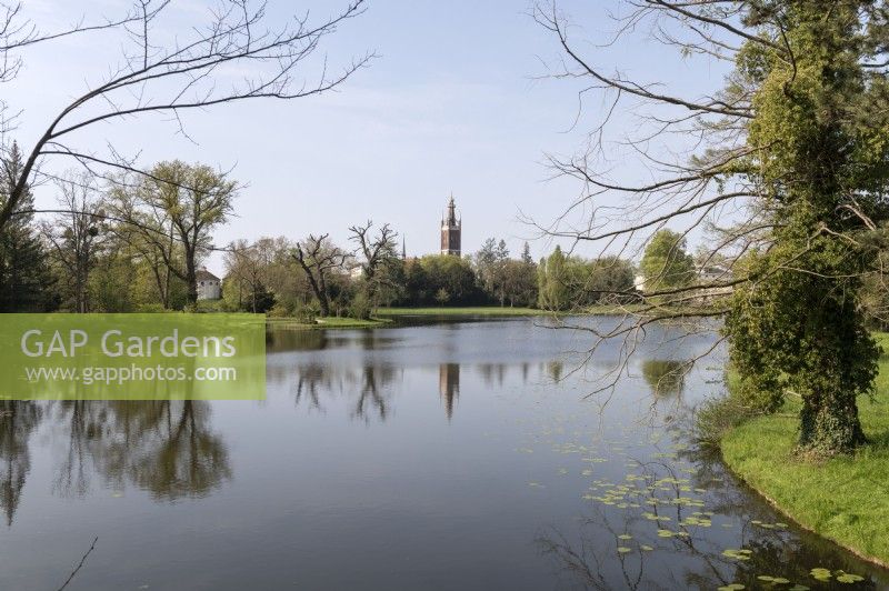 Woerlitz Saxony Anhalt Germany 
Dessau-Woerlitzer Gartenreich garden realm. A UNESCO World Heritage site. 
Woerlitz Anlagen landscape gardens. St peters Church St.-Petri-Kirche tower reflected in a lake.