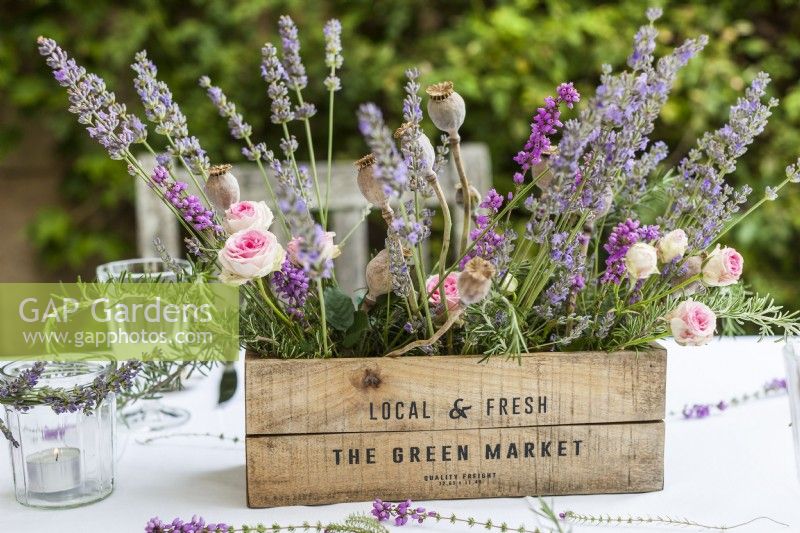 Table centrepiece of timber box filled with lavender, roses and poppy seedheads - Lavender summer party story