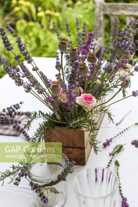 Table centrepiece of timber box filled with lavender, roses and poppy seedheads - Lavender summer party story
