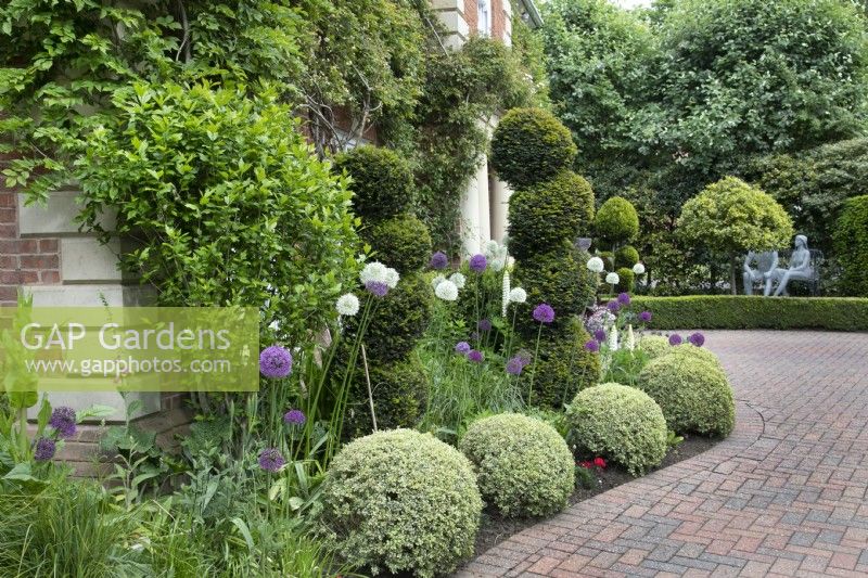 Topiary and wire sculptures by Derek Kinzett in the front garden at Hamilton House, in May