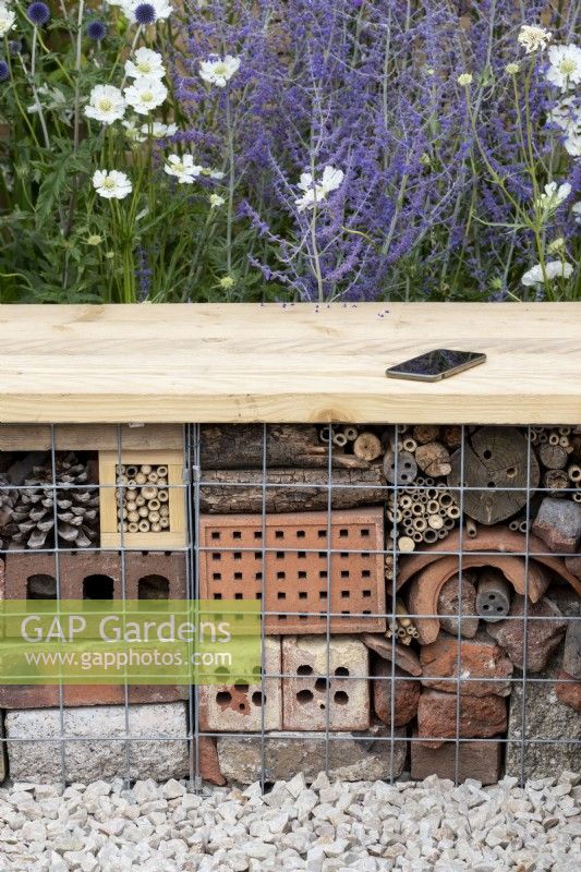 Insect hotel seating in the Turfed Out garden at RHS Hampton Court flower show 2022 - Designed by Hamzah-Adam Desai