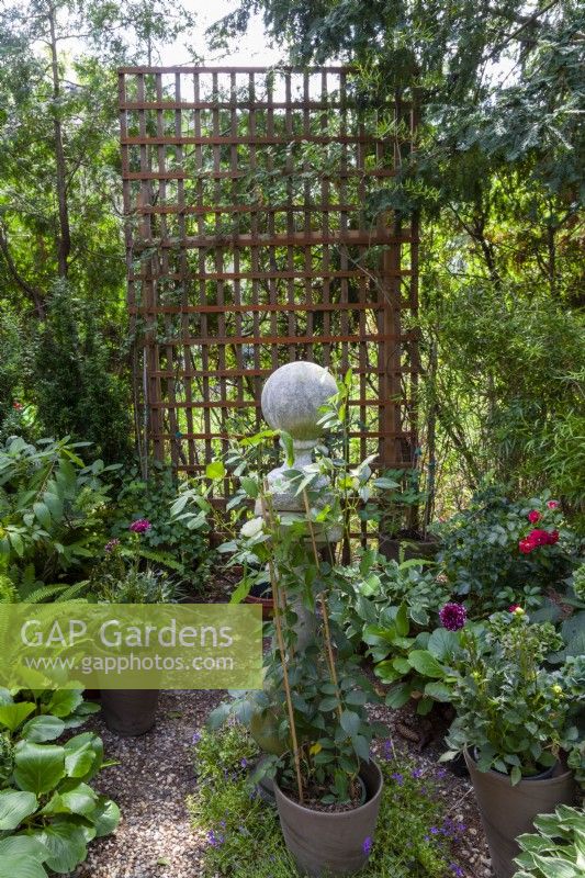 Trellis with garden decoration and potted plants
