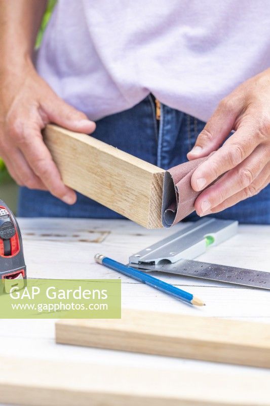 Woman sanding the pieces of wood