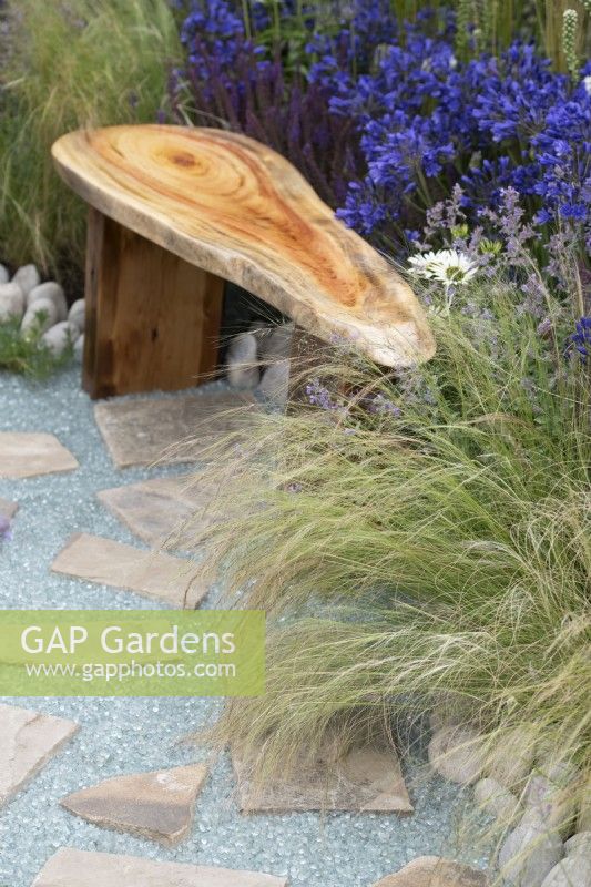 Stipa tenuissima - Mexican feather grass and Recycled glass stone pathway on the Journey Home garden RHS Tatton Park Flower Show 2022 - Designed by Rachael Bennion and Petrus Community