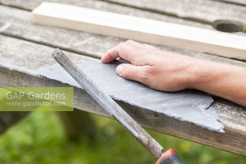 Woman using the file to smoothen the edge of the slate