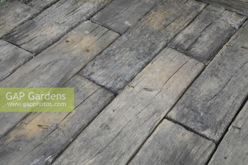 Paving made from old railway sleepers in the Marshalls Landscaping Garden at BBC Gardeners World Live 2022