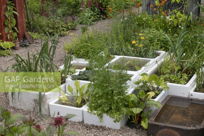 Reclaimed stone sinks as planters and water features in Frances' Garden at BBC Gardeners World Live 2022