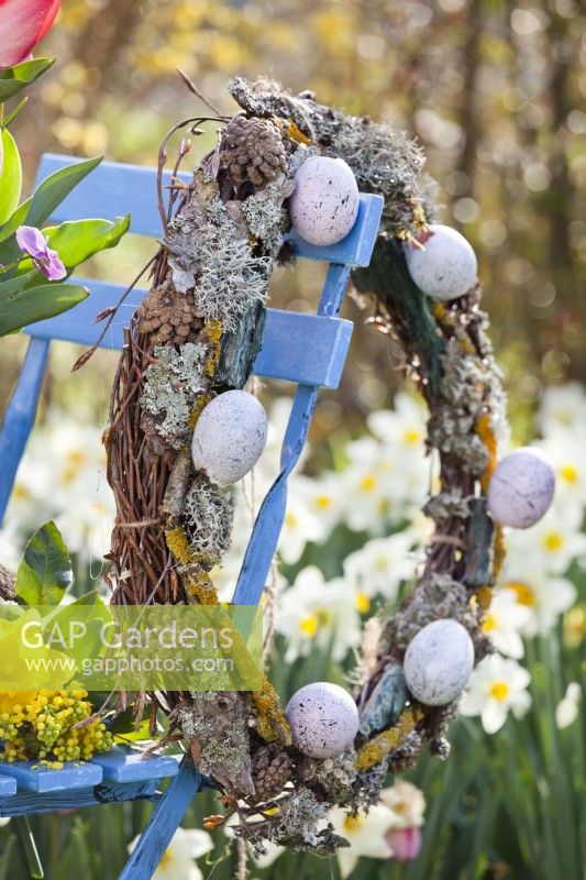 Easter wreath made of beech branches, lichens and coloured eggs.