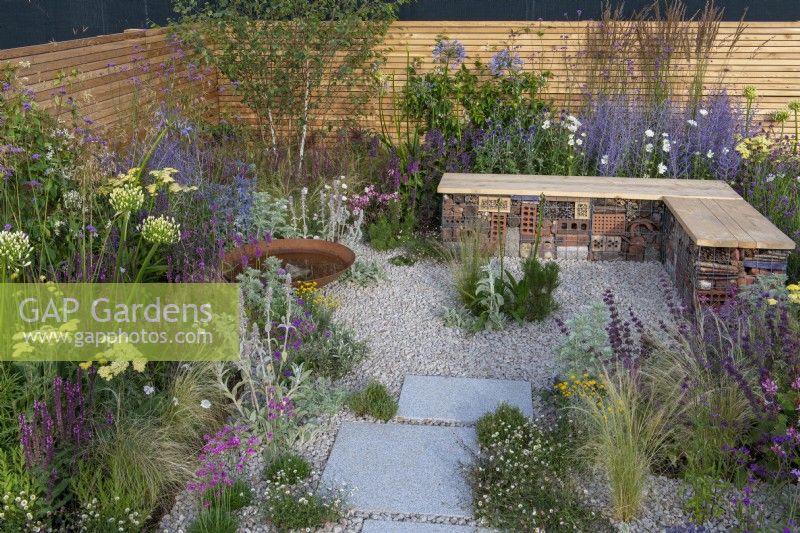 A sustainable, low maintenance gravel garden filled with drought tolerant plants to attract pollinators, such as salvia, achillea, sea pinks, echinops, fleabane, perovskia, agapanthus, sea hollies and catmint.