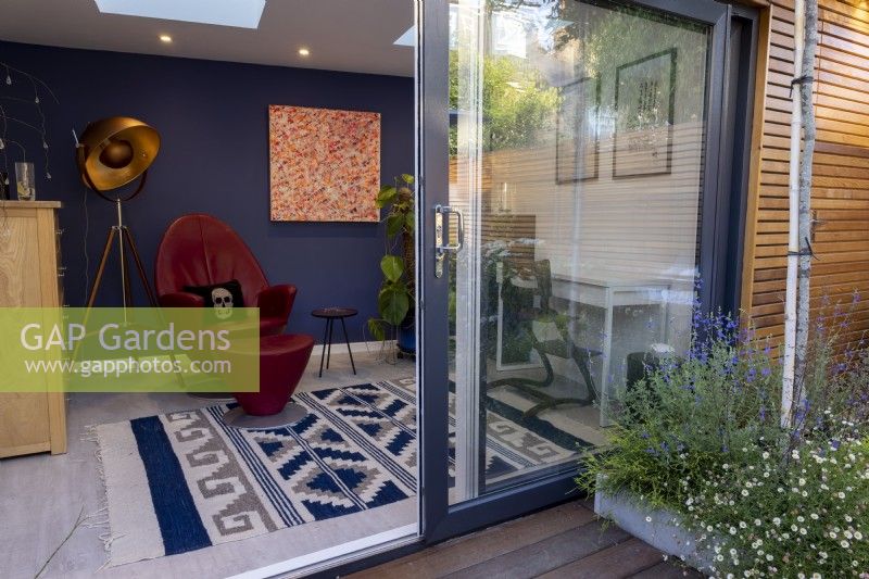 Garden office with raised bed outside. View into interior of office