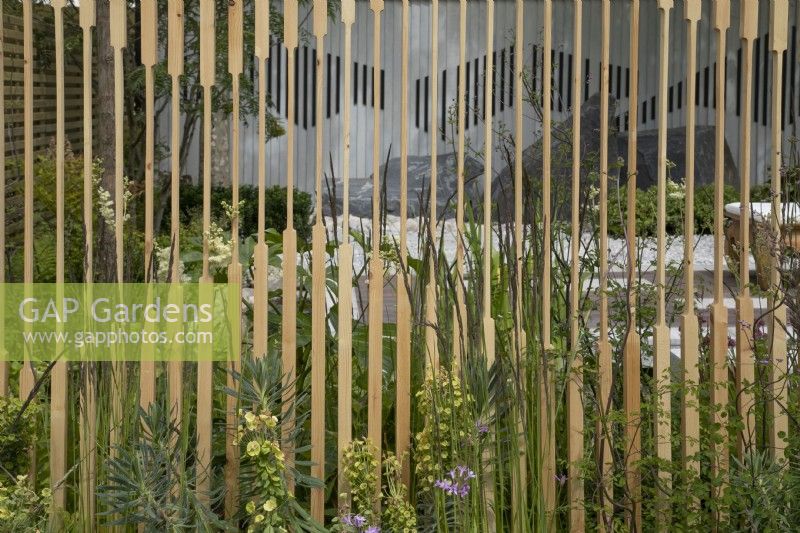 View through the screen in The Memories of Mountains Garden Retreat Garden at BBC Gardeners World Live 2022