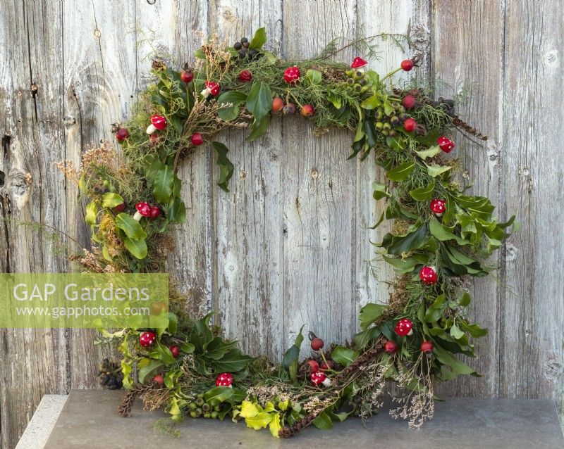 Completed Christmas wreath with porcelain toadstools and garden foliage