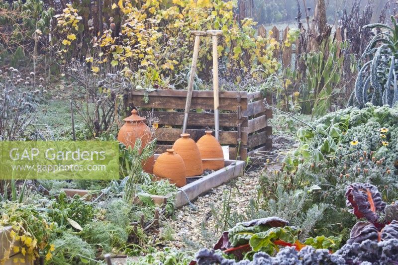 Kitchen garden with raised beds, compost heap and tools.