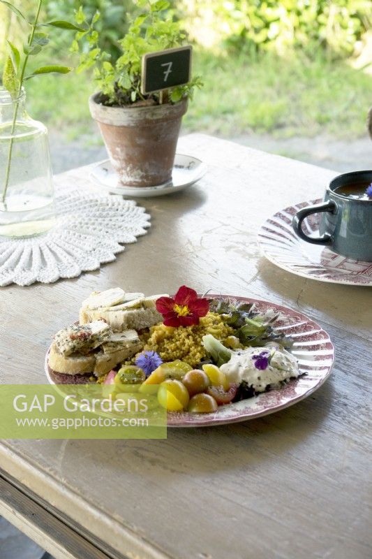 Plate of fresh salads with garnish of edible flowers.