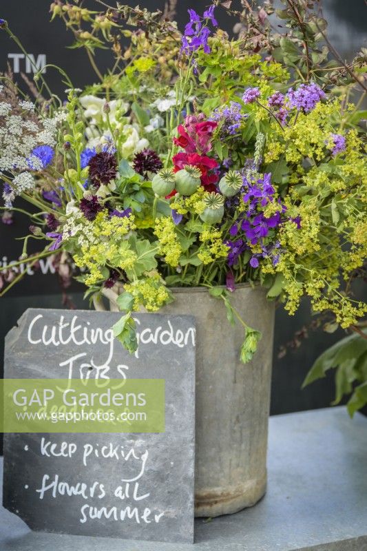 Cottage garden flowers in a vase with memo chalkboard with cutting garden jobs info at RHS Hampton Court Palace Garden Festival 2022 