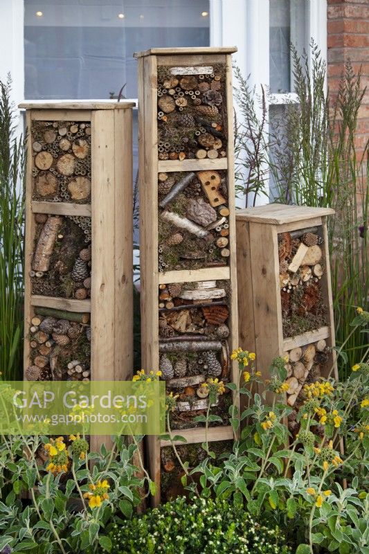 Tiered insect hotels made from recycled materials in the 'Living in Sync' garden at BBC Gardener's World Live 2017 - June