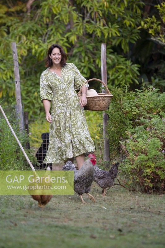 Garden owner, Susie Harris-Leblond walking with her pet chickens
