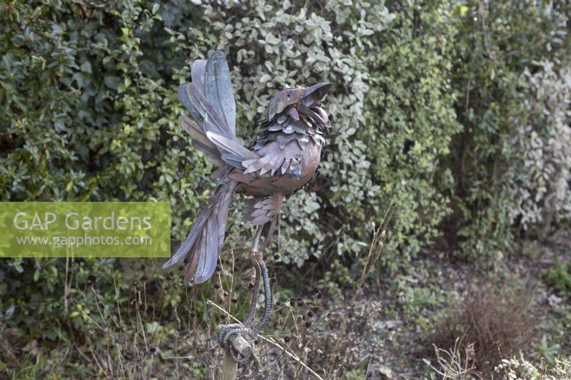 Doug 2, a bird sculpture on an old wooden tool handle. Made by Michael Kusz out of recycled metal. February. 