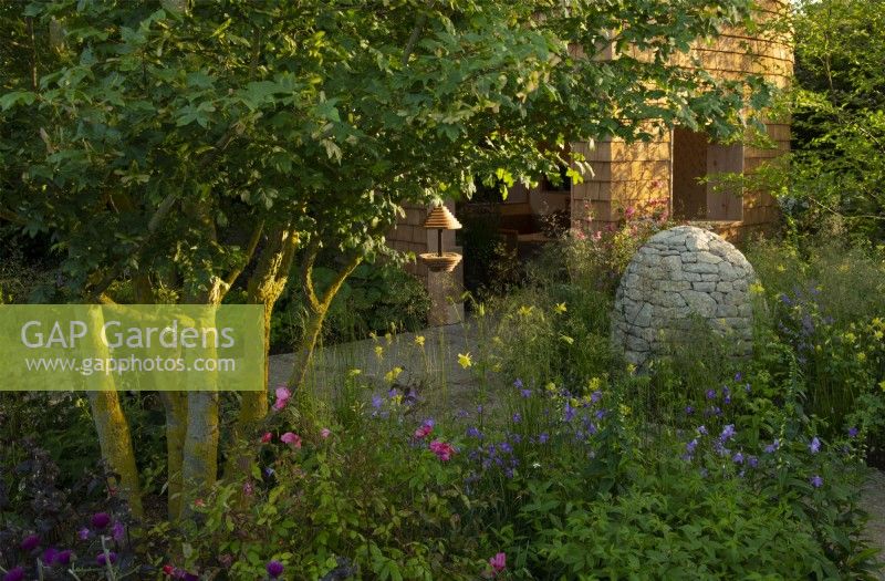 Horatio's Garden, a show garden featuring a woodland retreat, stone cairns, herbaceous planting and accessible areas for people affected by spinal injuries.  Designed by Charlotte Harris and Hugo Bugg.