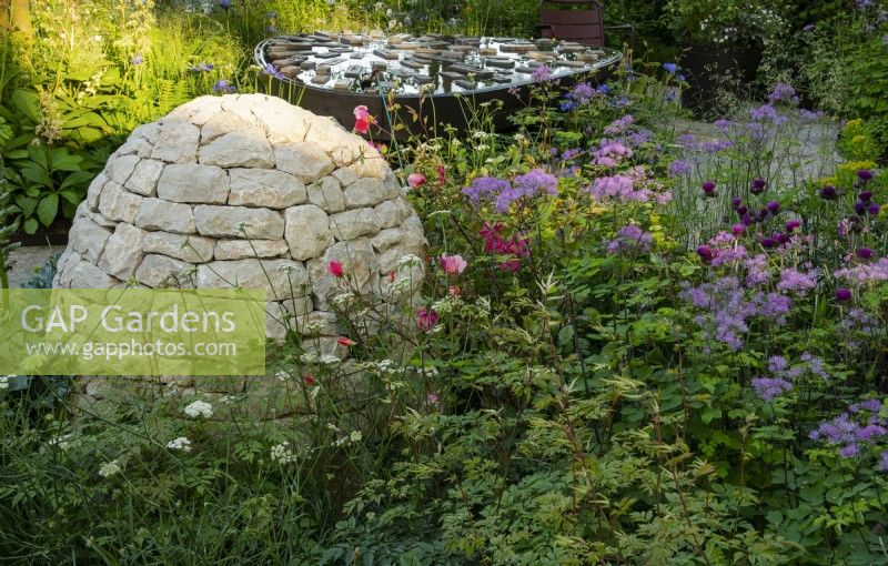 Horatio's Garden, a show garden designed by Charlotte Harris and Hugo Bugg featuring a stone cairn and water feature surrounded by herbaceous planting  and accessible areas for people affected by spinal injuries.  