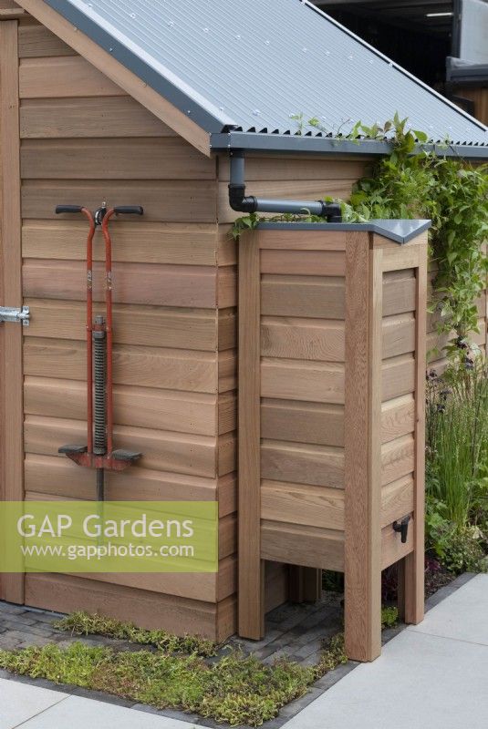 Cedar garden shed with a waterbutt attached to the roof gutter.

The Gabriel Ash showstand at RHS Chelsea Flower Show 2023.