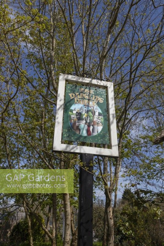 The pub sign for the licensed mini thatched pub in the Devon Scene Garden. Trago Mills show gardens, Devon, UK. May. Spring