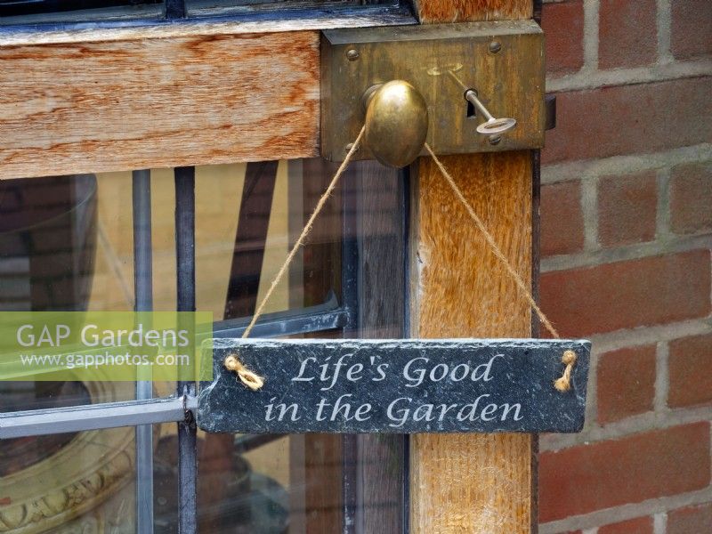 Garden sign  hanging on entrance door  July Summer