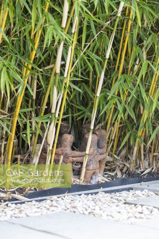 Ring of people garden ornament among bamboo