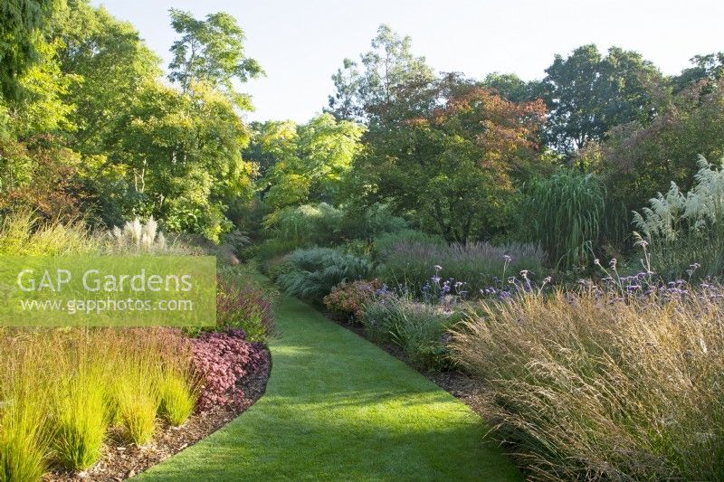 Mixed perennial borders line the lawned path of ''The Long Walk' at Knoll Gardens in Dorset