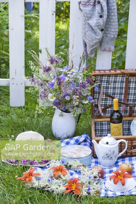 Set for picnic with floral arrangements.