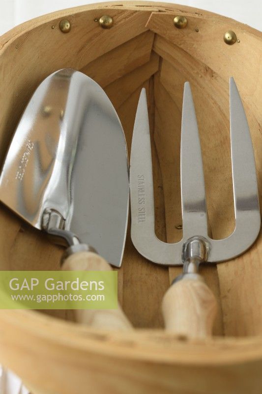 Gardening hand tools in wooden trug  May