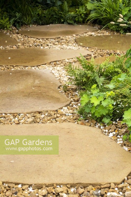 A natural paving and gravel path on The London Square Community Garden - Sanctuary Gardens - Designer James Smith - RHS Chelsea Flower Show 2023