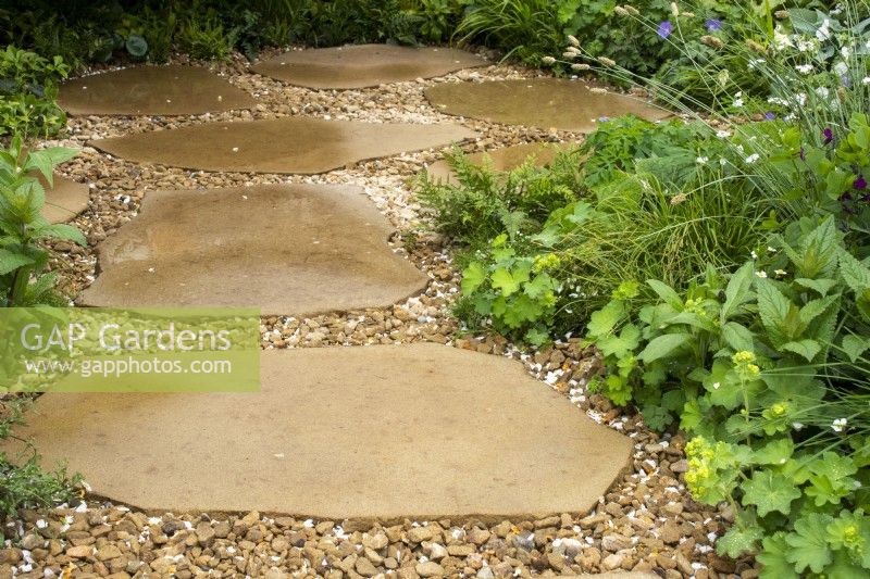 A natural paving and gravel path on The London Square Community Garden - Sanctuary Gardens - Designer James Smith - RHS Chelsea Flower Show 2023