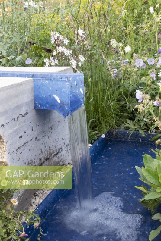 A rill made of recycled plastics surrounded by wildlife friendly planting on the RSPCA Garden designed by Martyn Wilson - RHS Chelsea Flower Show 2023