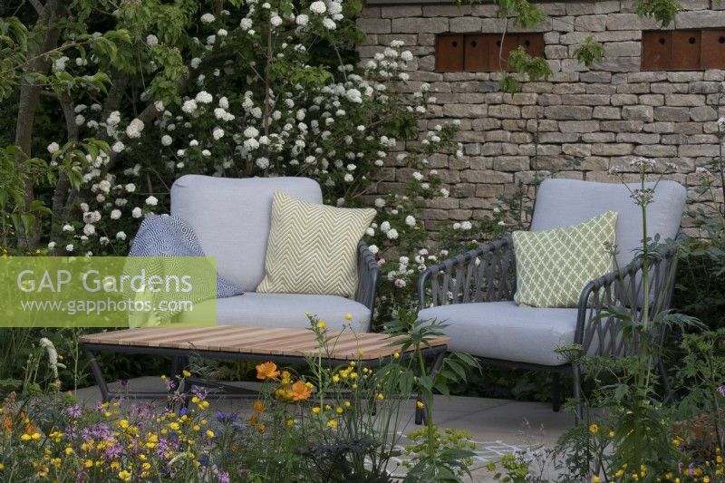 Wildlife friendly planting surrounds a secluded seating area on the RSPCA Garden designed by Martyn Wilson - RHS Chelsea Flower Show 2023