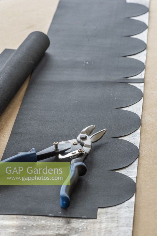 Step-by-Step Making a Plant Theatre. Step 20: cut a scalloped template from a scrap piece of black fabric, and lay it out on the 1m length of lead flashing. Leave a central 20mm wide flap, to allow for the scalloping to overlap tidily when the lead is fitted over the 90 degree angle of the roof's apex