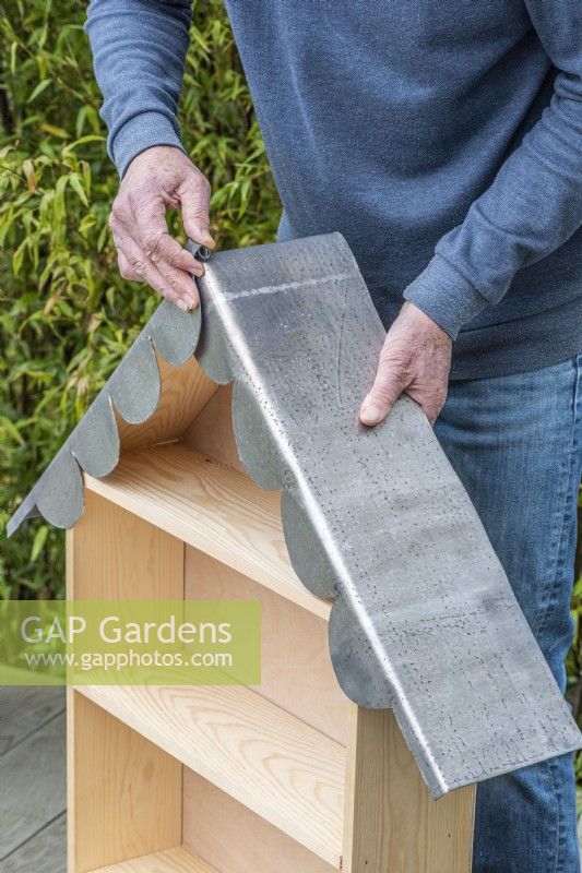Step-by-Step Making a Plant Theatre. Step 23: carefully fit the lead to the roof, overlapping the central scalloping beneath the flap which is rolled up. 20mm is allowed to bend over the back edge, protecting the edges of the marine ply from rain