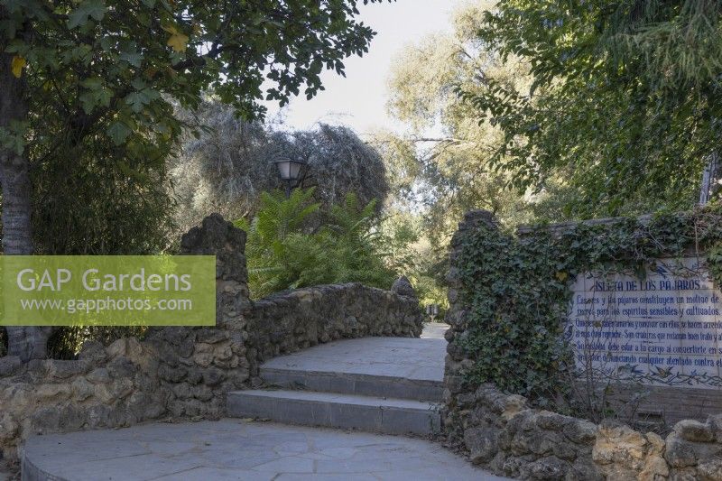 Steps lead up to a stone bridge. Parque de Maria Luisa, Seville, Spain. September