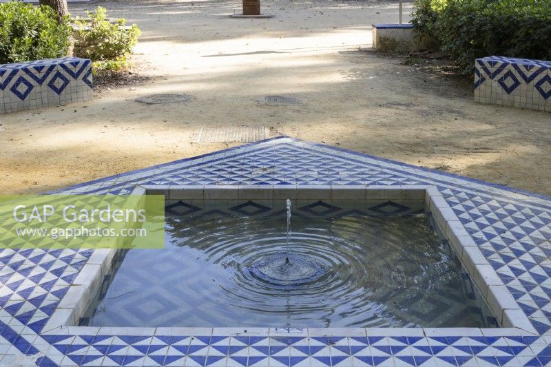 A geometric, tiled fountain in the Mudejar, Islamic style. Parque de Maria Luisa, Seville, Spain. September