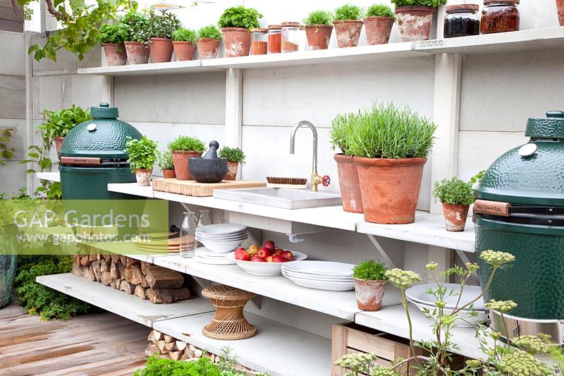 Outdoor kitchen with herb pots 
