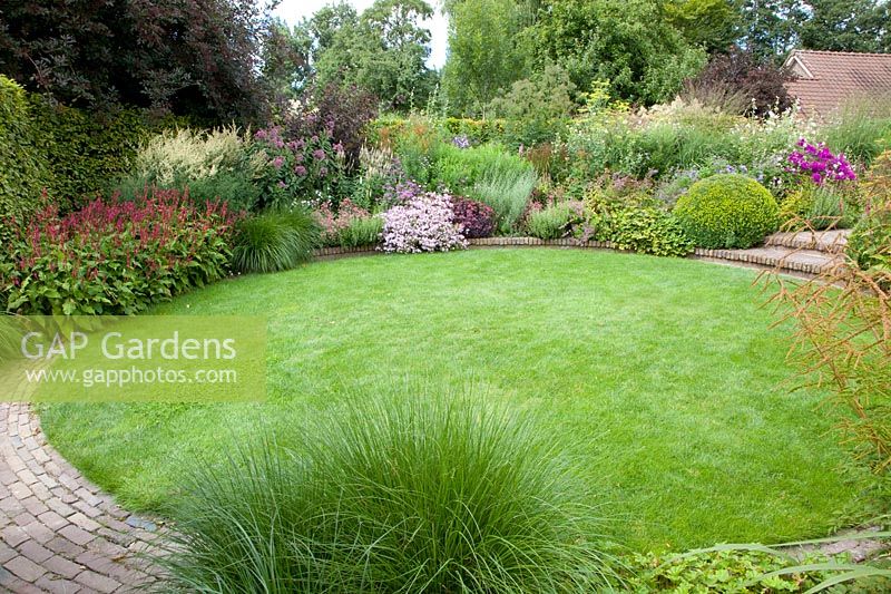 Lawn circle with bed, Sedum Purple Emperor, Artemisia, Saponaria lempergii Max Frei, Persicaria amplexicaulis Border Beauty, Veronicastrum, Sedum Abbeydore, Pennisetum alopecuroides 