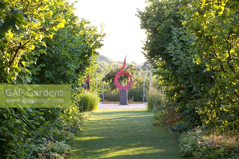 Hazelnut avenue with sculpture by Eric Ferber 