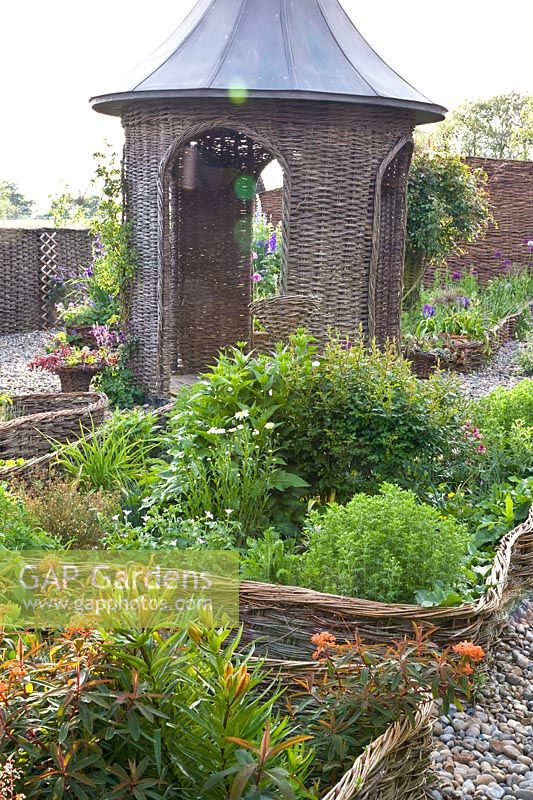 Cottage garden with willow fences and gazebo 