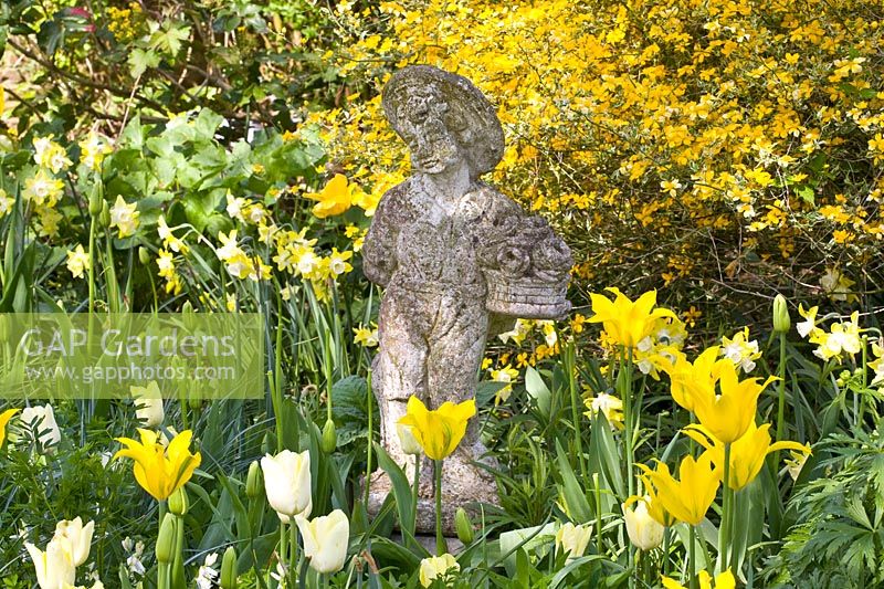 Tulips with putto in front of ranunculus bush 