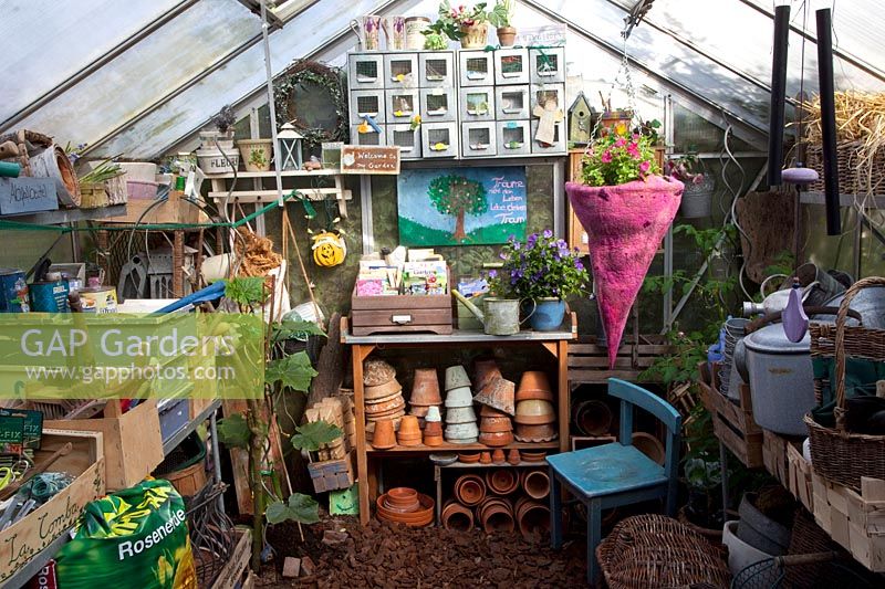 Interior view of greenhouse with gardening utensils 