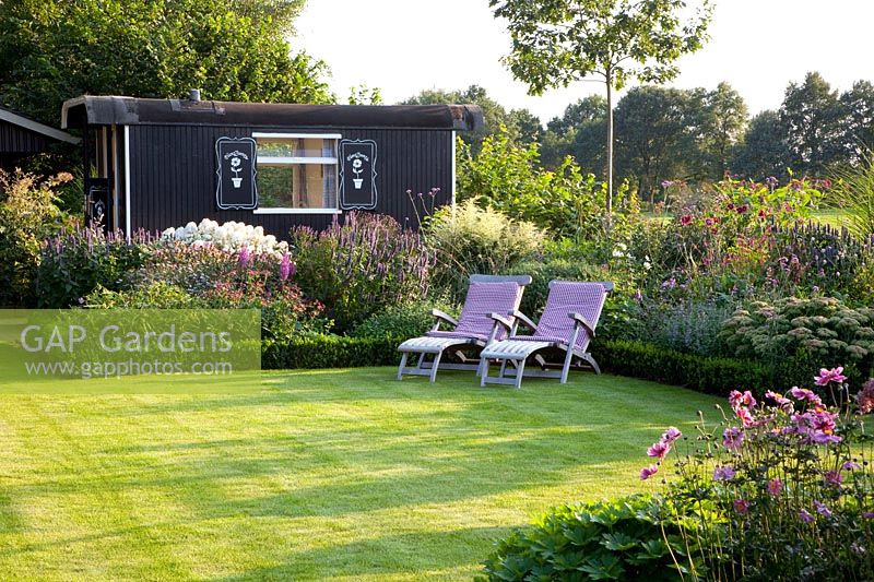 Seating area in front of garden house 