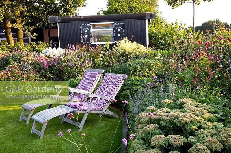 Seating area in front of garden house 