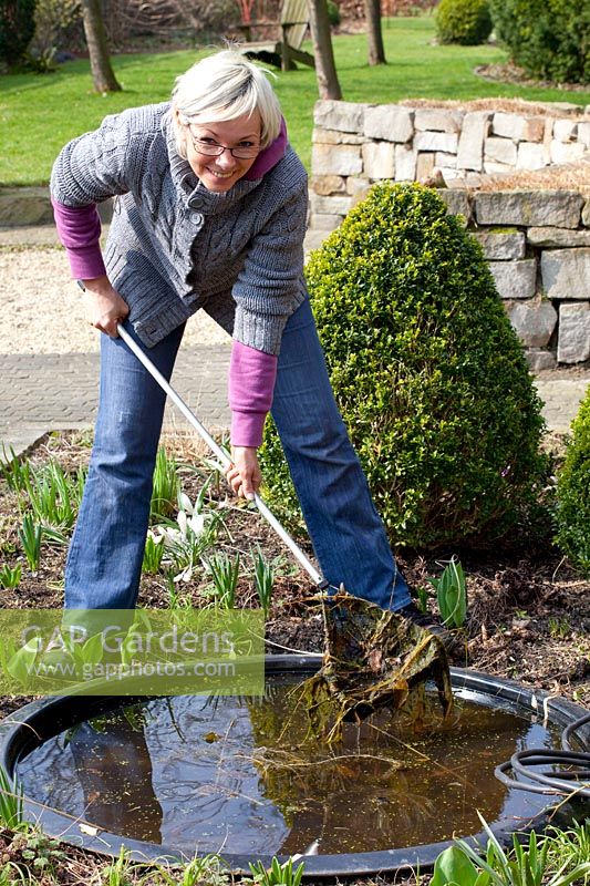 Fishing algae out of the pond 