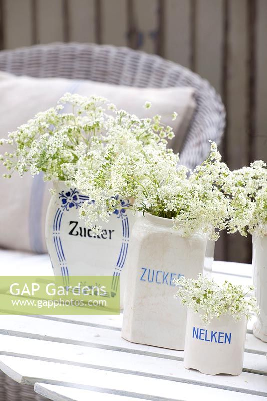 Antique storage jars with cow parsley 